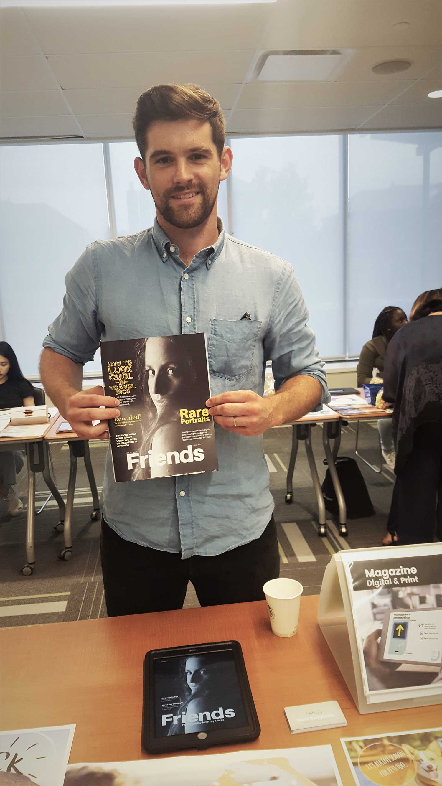 student posing with a magazine