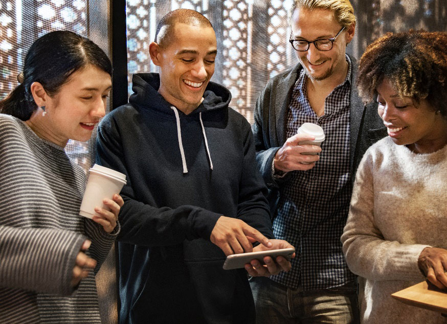 group of people looking at a tablet