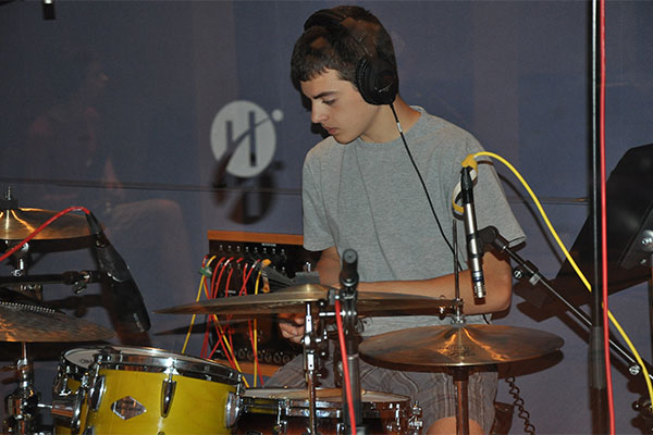 young person playing the drums