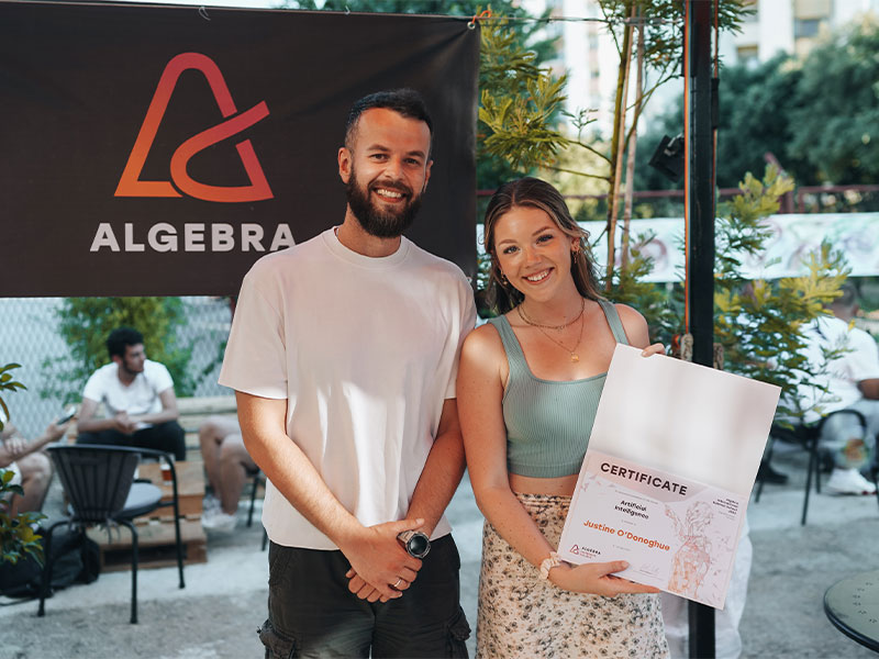 Two people in front of Algebra sign