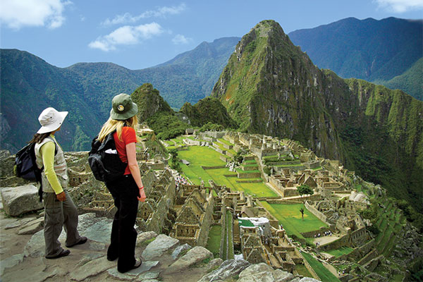 Two people looking over Machu Picchu in Peru