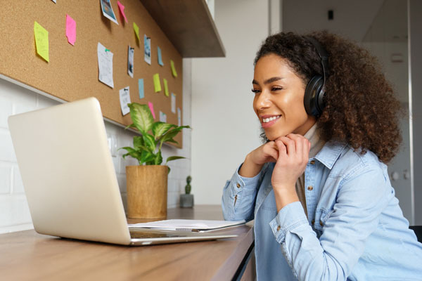 Person wearing headphones using laptop