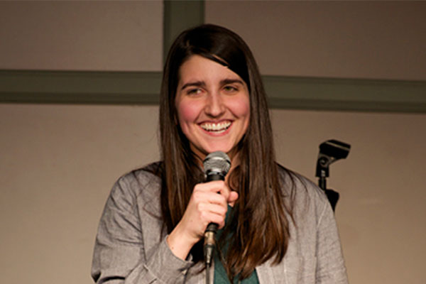 person smiling with microphone