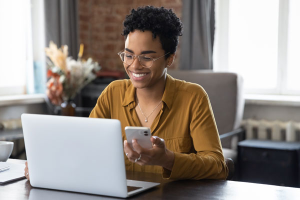 person using laptop and mobile phone