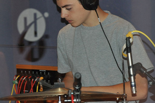 young person playing drums