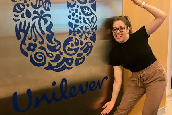 Amanda posing with Unilever sign