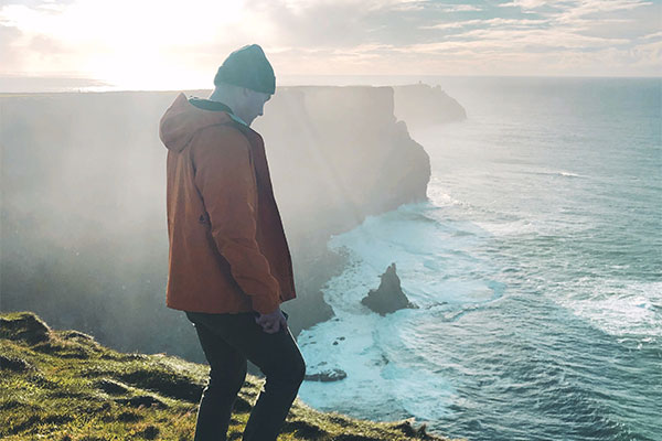 Patrick at a cliff looking out to the water