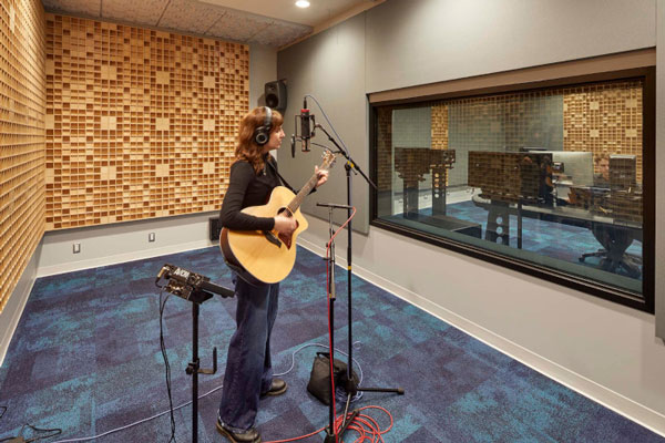 Guitar player inside recording studio