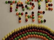 Skittles arranged to read "taste the rainbow"