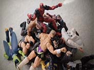 Deadpool toy sitting on a pile of action figures