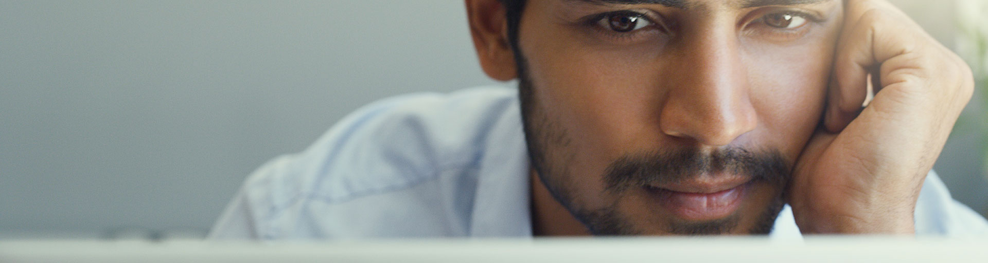 male sitting looking at laptop