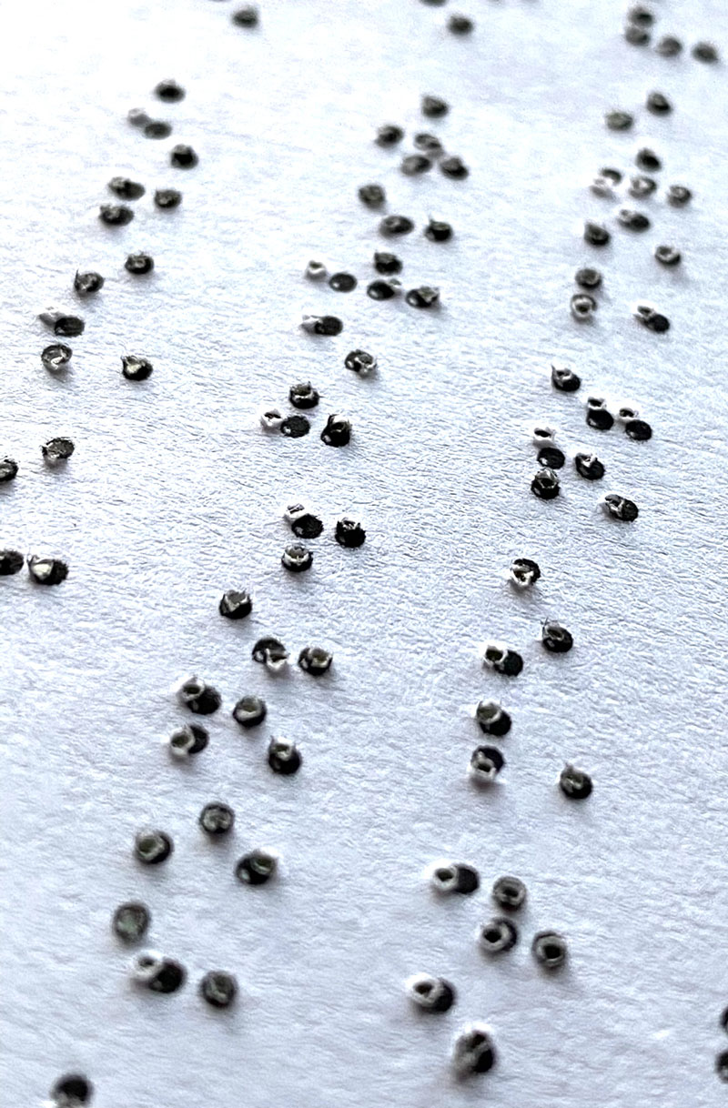 hand-created braille dots textured on a sheet of paper