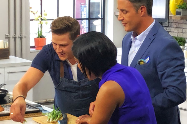 Paul Lillakas preparing food on a tv show