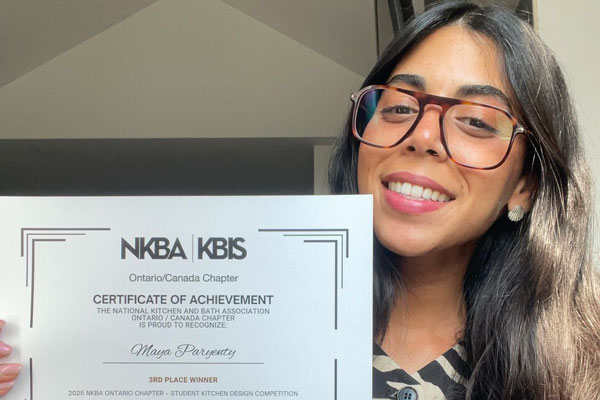 Maya Paryenty holding her NKBA Ontario Chapter Student Design Competition certificate