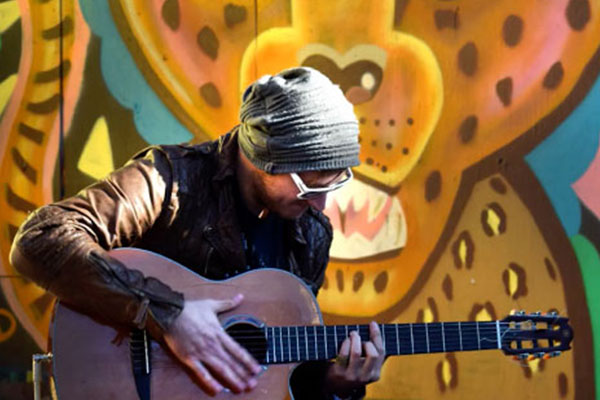 male playing a guitar