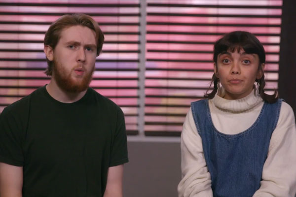 Two people talking side by side