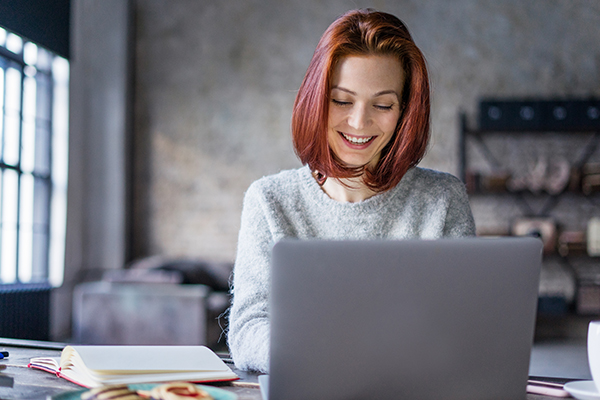 Woman smiling at laptop
