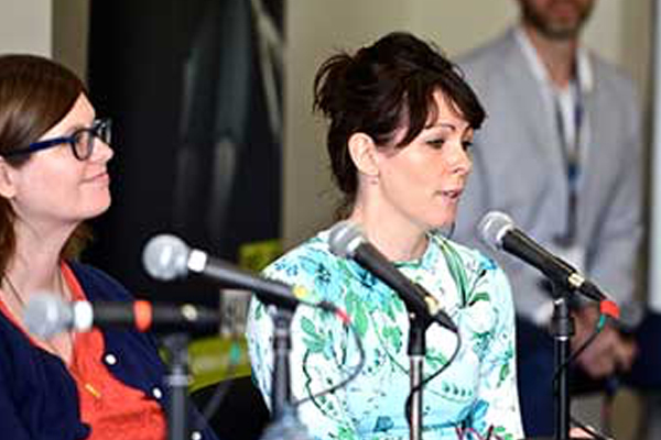Two women speaking at a workshop panel