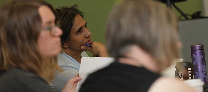 Students listen to past mentor Jenny Offill giving feedback during the 2018 Summer Workshop in Creative Writing.