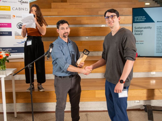 Student shaking hand with award donor