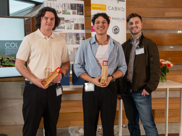 Two awarded students pose with another person