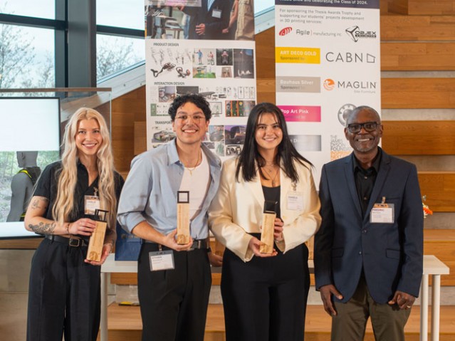 Three awarded students pose with person