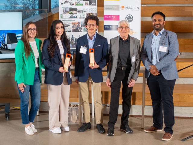 Three people pose with two awarded students