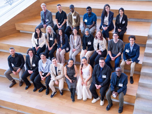 Group shot of Industrial Design graduating class and professors sitting on stairs