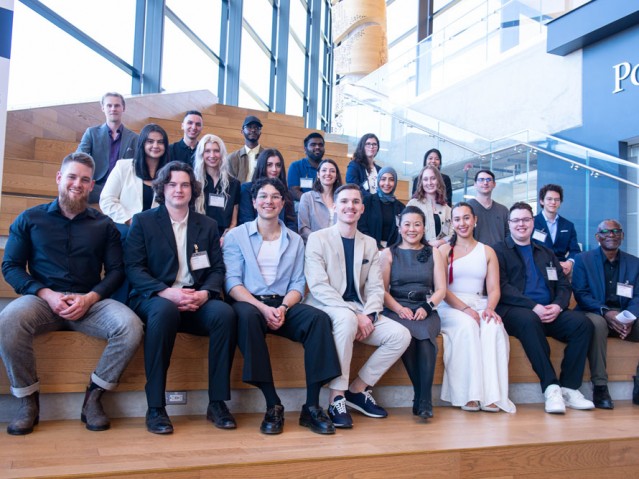 Group shot of Industrial Design graduating class and professors sitting on stairs