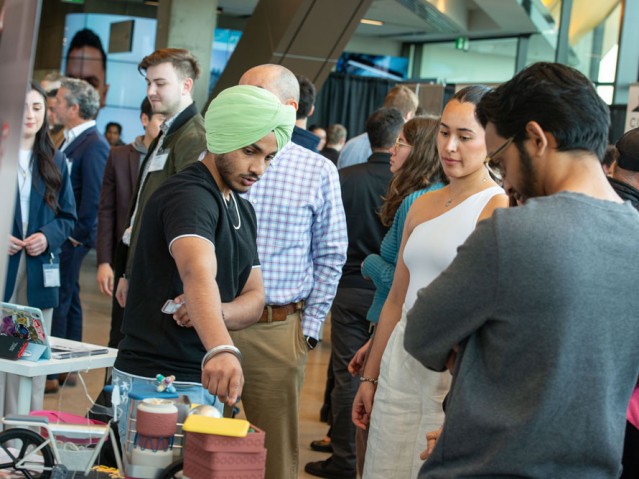 Guests looking at a student's project