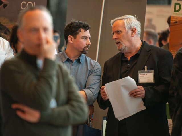 Two people talking in crowd