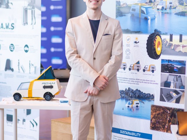 Isaac Kerr stands beside his project poster