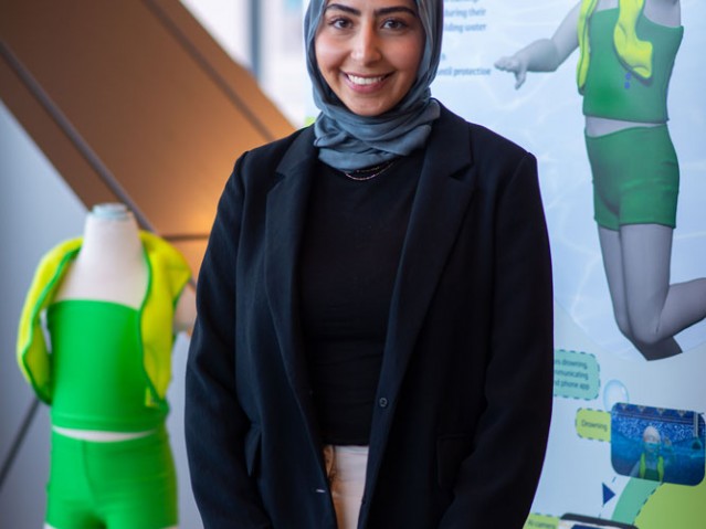 Raneem El Kadri stands in front of her project poster