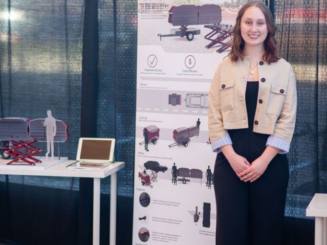 Eve Mills stands in front of her Mech X Press project poster