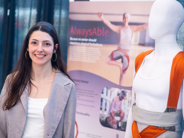 Student stands in front of her AlwaysAble project poster