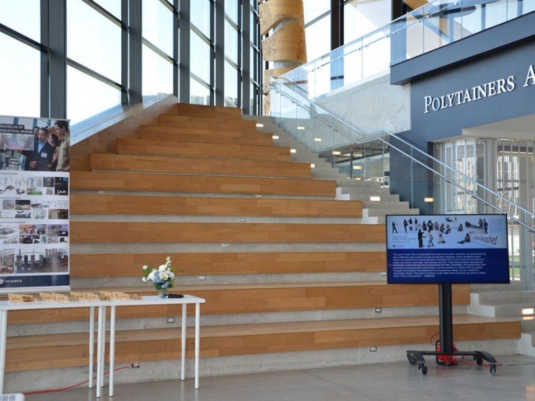 Table with awards and poster in front of staircase