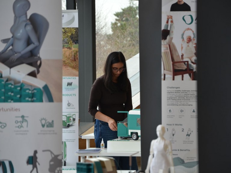 Person looking down at a physical model of a project