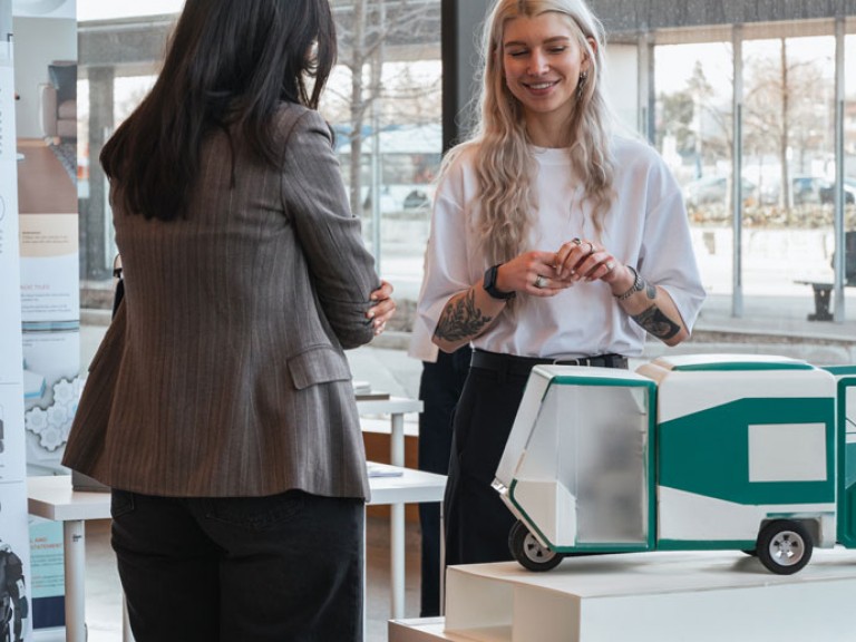 Two people looking at project model