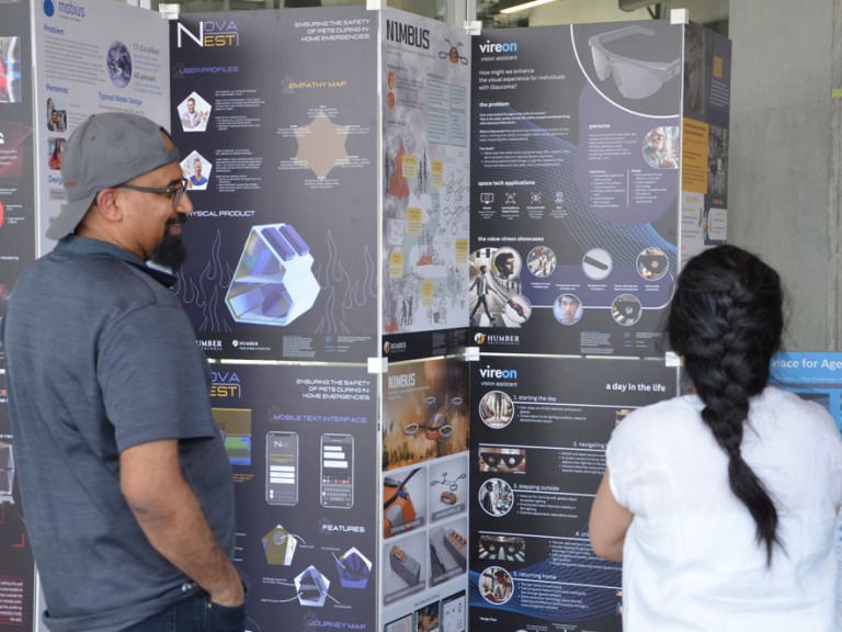 Two people looking at display posters