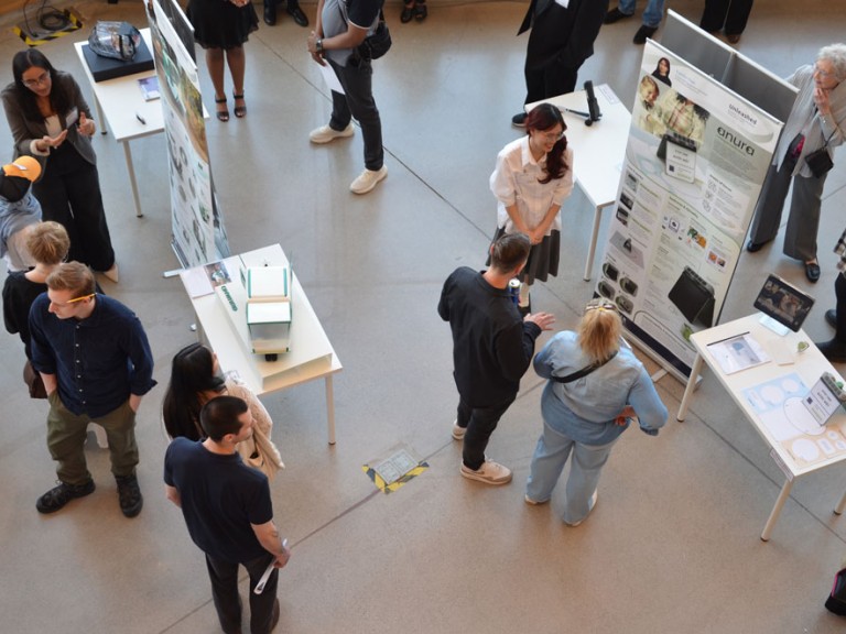 Bird's eye view of people lingering around project displays