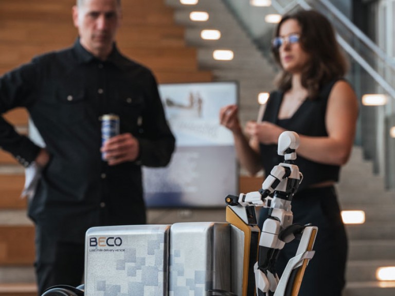 Two people in the distance behind a project model