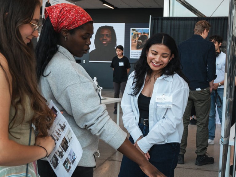 Design graduate talking with guests