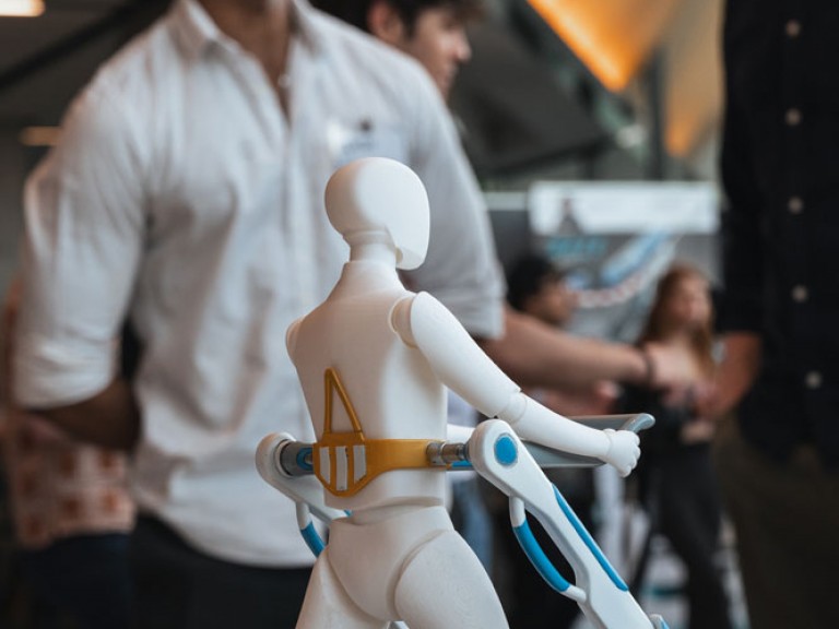 Two people in the distance behind a project model