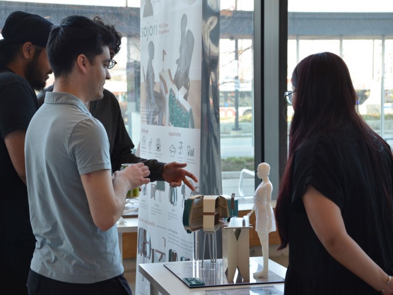 Event guests looking at project model