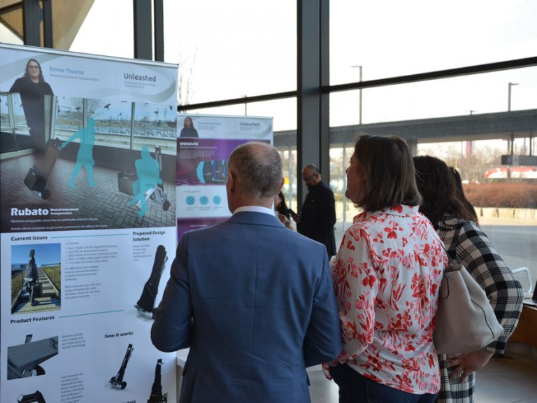 People looking at display poster