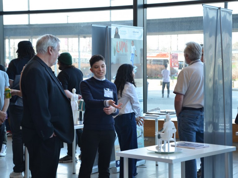 Design graduate in discussion with event guest