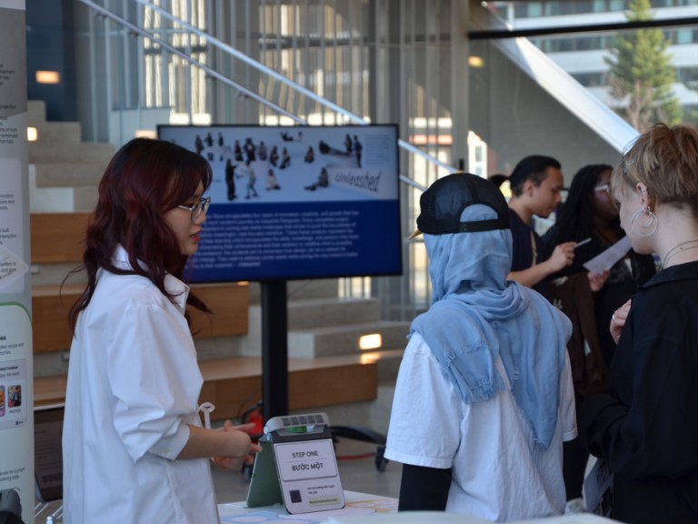 Design graduates talking with guests