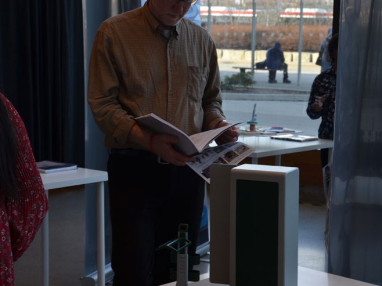 Event guest reads a project book