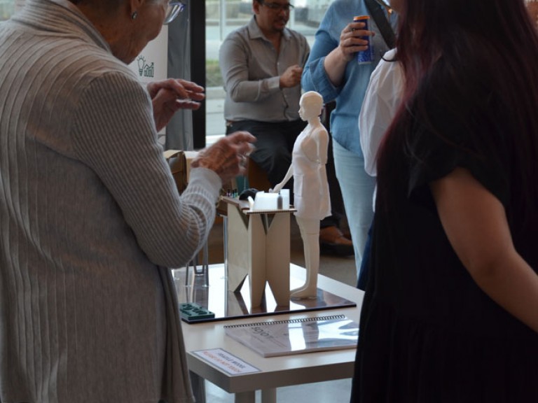 Event guest talking with graduate at table