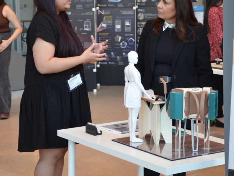 Two people in discussion at project table